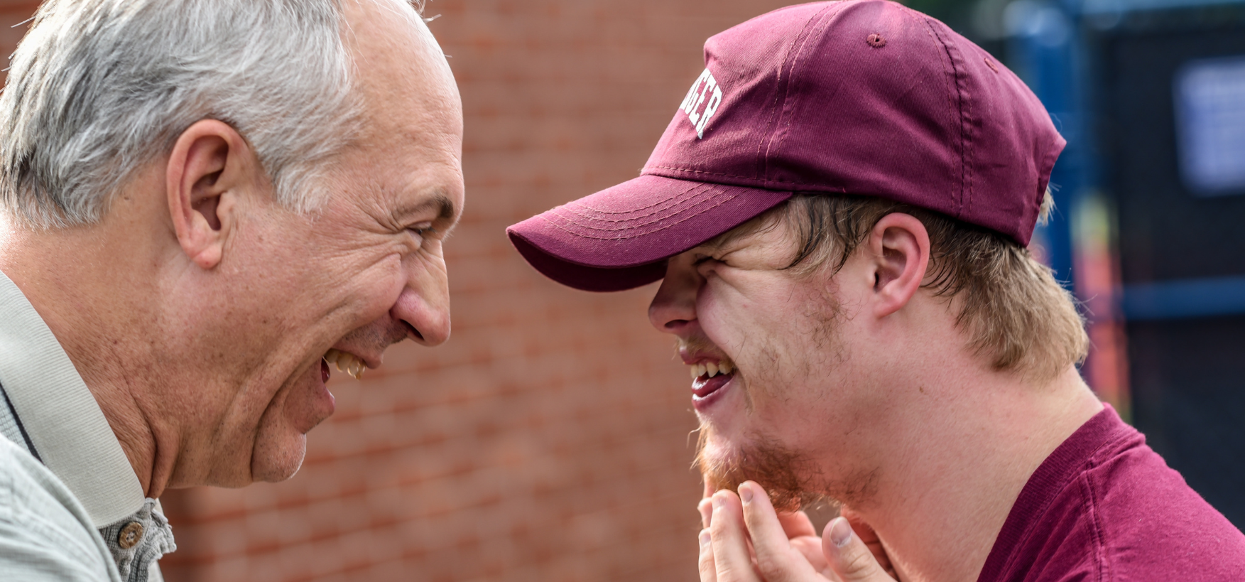 Accessibility image of Elderly man laughing with young man